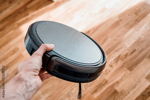 robotic vacuum cleaner on the hand photo