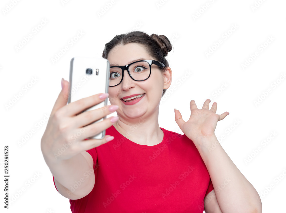 Funny happy young woman in glasses with smartphone make selfie, isolated on white background. Funny happy young woman in glasses with smartphone make selfie, isolated on white background.