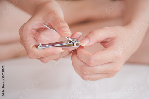 Closeup of a woman cutting nails, health care concept, selective focus.