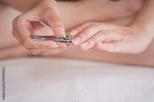Closeup of a woman cutting nails  health care concept  selective focus.