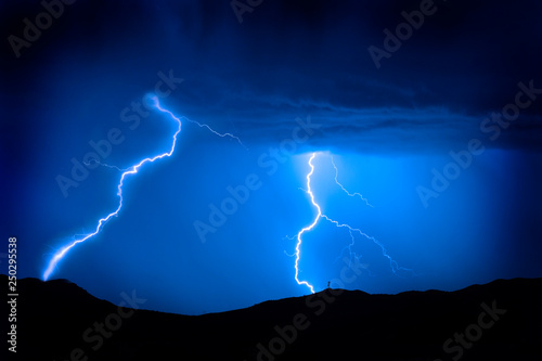 Lightning Bolts on Mountain with Radio Tower Blue Sky