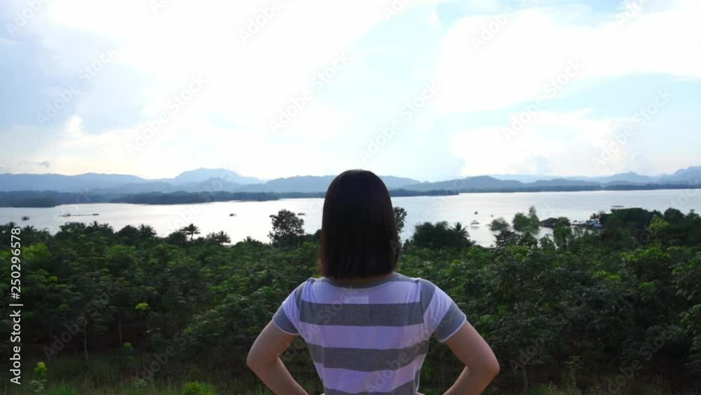 young japanese teen girl brunette tourist adult woman asian mature backpack looking the sky outdoors on a hike mountains viewpoint at khao Laem dam national park, kanchanaburi, Thailand. young japanese teen girl brunette tourist adult woman asian mature backpack looking the sky outdoors on a hike mountains viewpoint at khao Laem dam national park, kanchanaburi, Thailand.