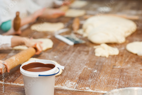 Young children make dough products. Hands closeup