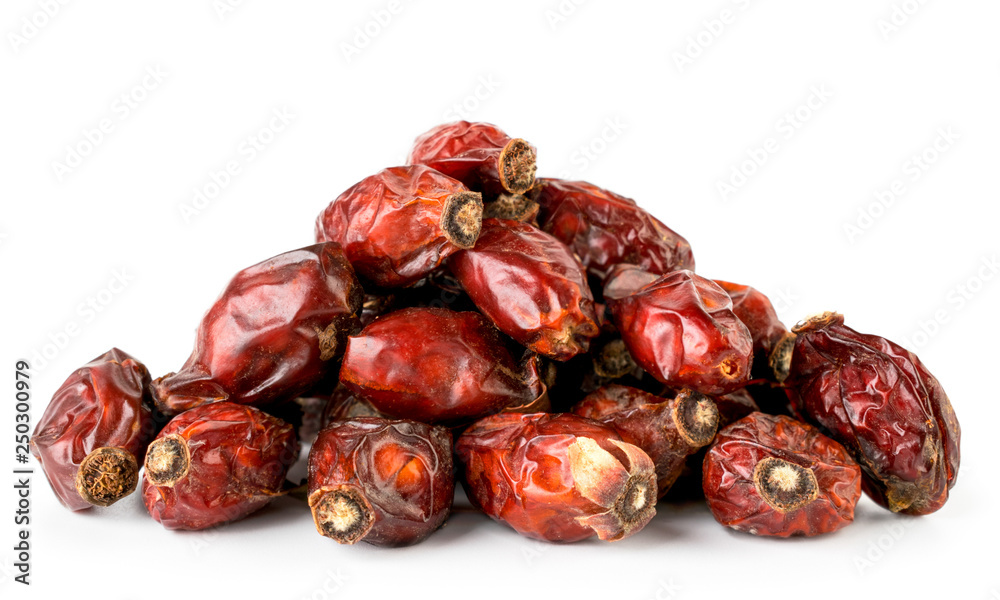 Heap of dry rose hip close up on a white. Isolated. Heap of dry rose hip close up on a white. Isolated.