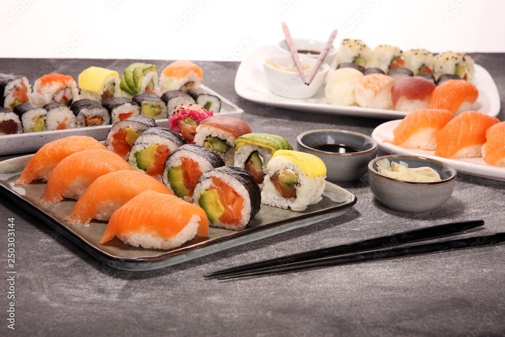 close up of sashimi sushi set with chopsticks and soy - sushi roll with salmon and sushi roll with smoked eel close up of sashimi sushi set with chopsticks and soy - sushi roll with salmon and sushi roll with smoked eel