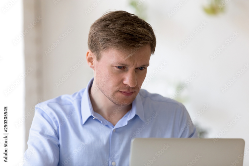 Pensive busy business man working on computer Pensive busy business man working on computer