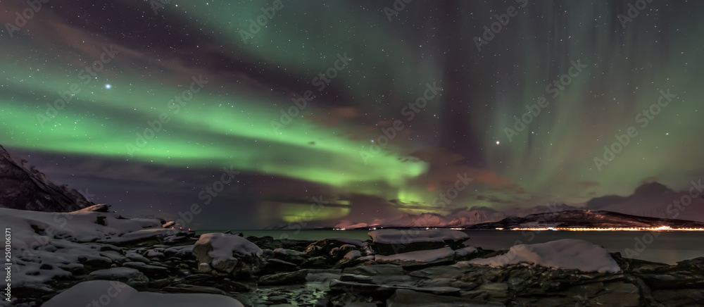 Amazing aurora borealis - northern lights - view from coast in Oldervik, near Tromso city -  north Norway - banner
