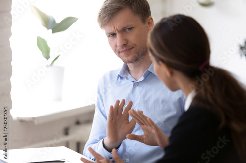 Team leader irritated man disagreed with colleague female photo