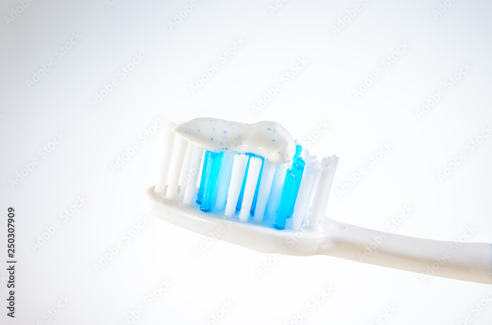 toothbrush with toothpaste on a wigh background, close up toothbrush with toothpaste on a wigh background, close up