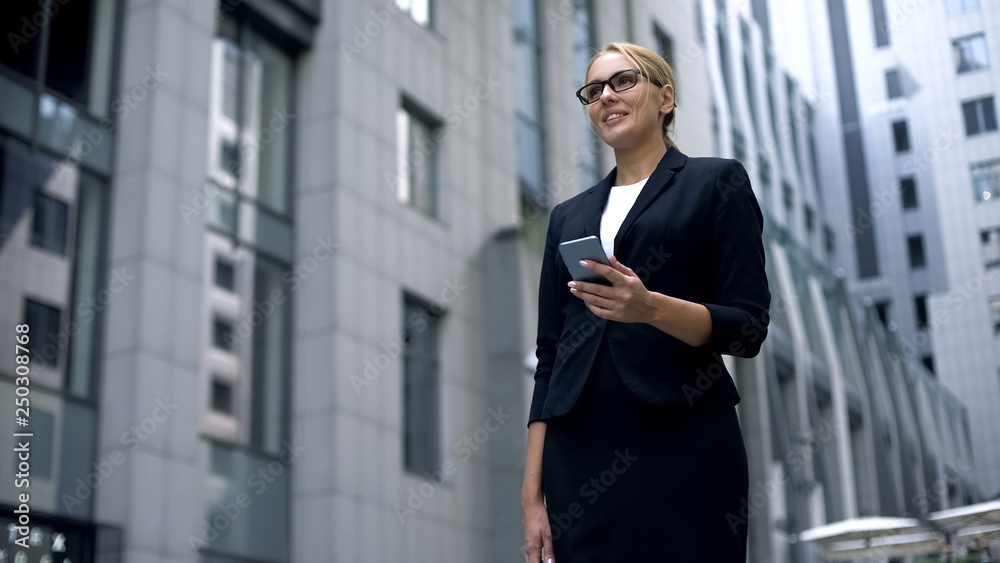 Business lady reads good news on cellphone, profitable contract and promotion Business lady reads good news on cellphone, profitable contract and promotion