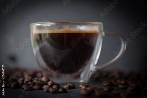 Coffee cup with fresh brewed coffee and brown roasted coffee beans
