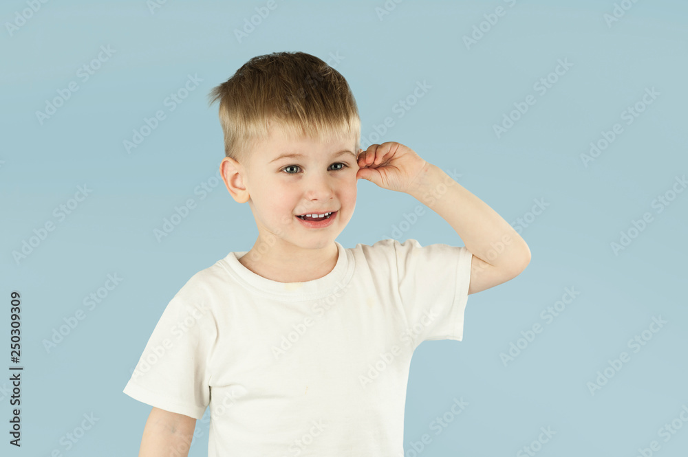 Portrait of an emotional boy on an isolated blue background. Portrait of an emotional boy on an isolated blue background.