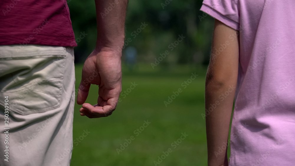 Hands of dad and son apart, divorce impact on children, lack of mens upbringing Hands of dad and son apart, divorce impact on children, lack of mens upbringing