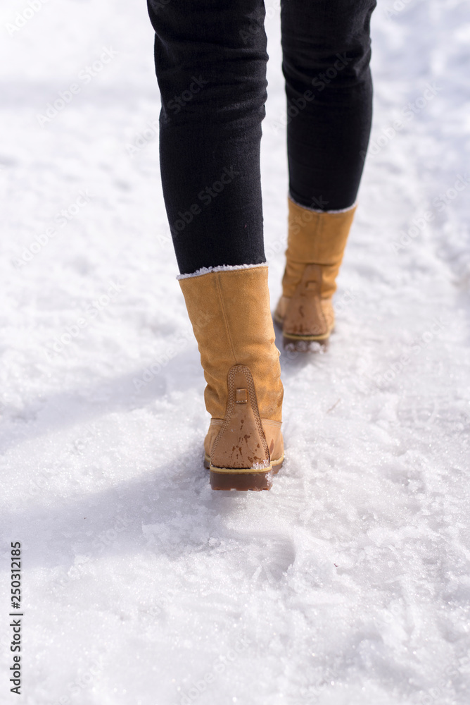 Young woman walking in the snow Young woman walking in the snow