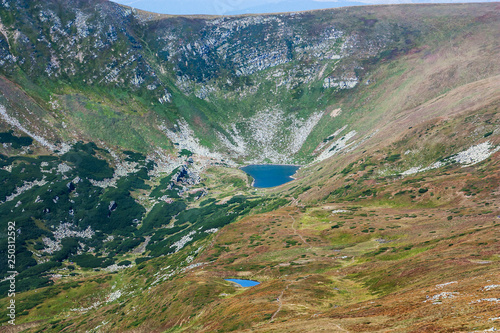 Panoramic view of a mountain lake in a rocky mountain valley. Serene lake Berbeneskul, Carpathians, Ukraine. photo