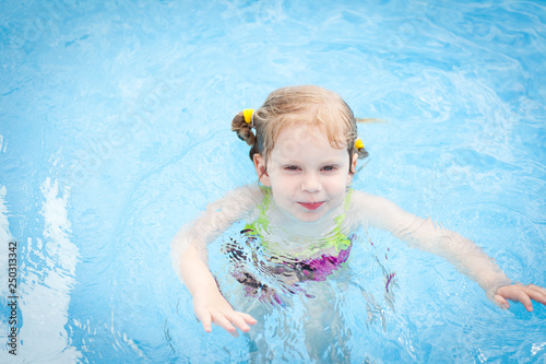 Happy Little Girl in Swimming Pool © IdeaBug, Inc.