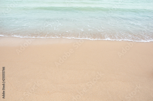 Soft wave of sea on empty sandy beach Background with copy space