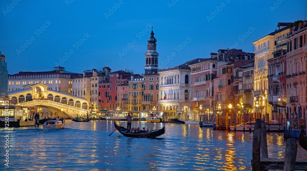 Italy beauty, evening with famous gondolas and Rialto bridge on Grand canal in Venice, Venezia