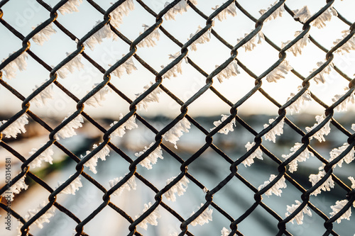 Chain link fence with barbed wire, background texture. 
