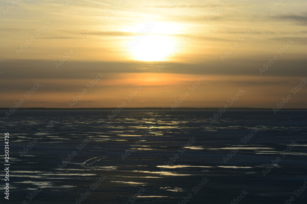 sunset over the frozen Gulf of Finland