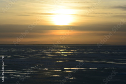 sunset over the frozen Gulf of Finland