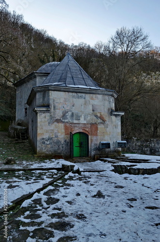 View toward temple with tomb and foundation of ancient building in Demir Baba Teke, cult monument honored by both Christians and Muslims in winter near Sveshtari village, Municipality Isperih, Razgrad photo