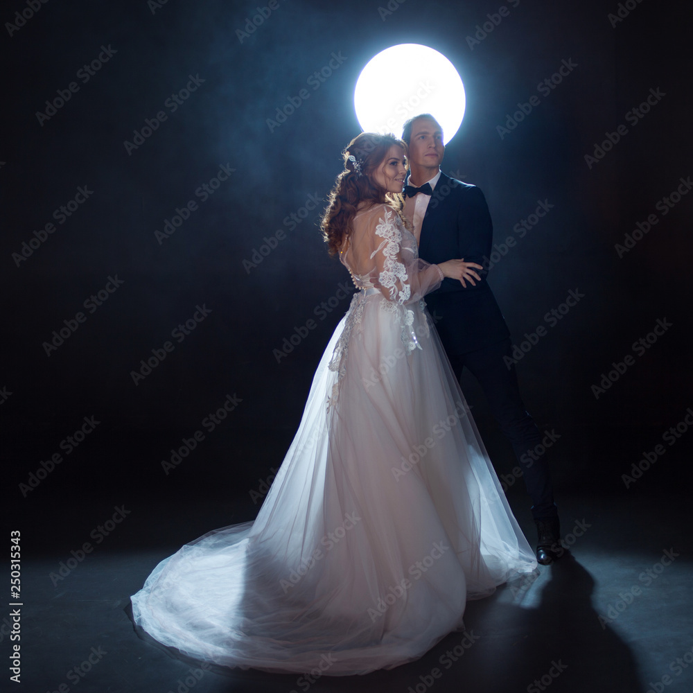 Mysterious and romantic meeting, the bride and groom under the moon. Hugs together. Man and woman, wedding dress. Mysterious and romantic meeting, the bride and groom under the moon. Hugs together. Man and woman, wedding dress.