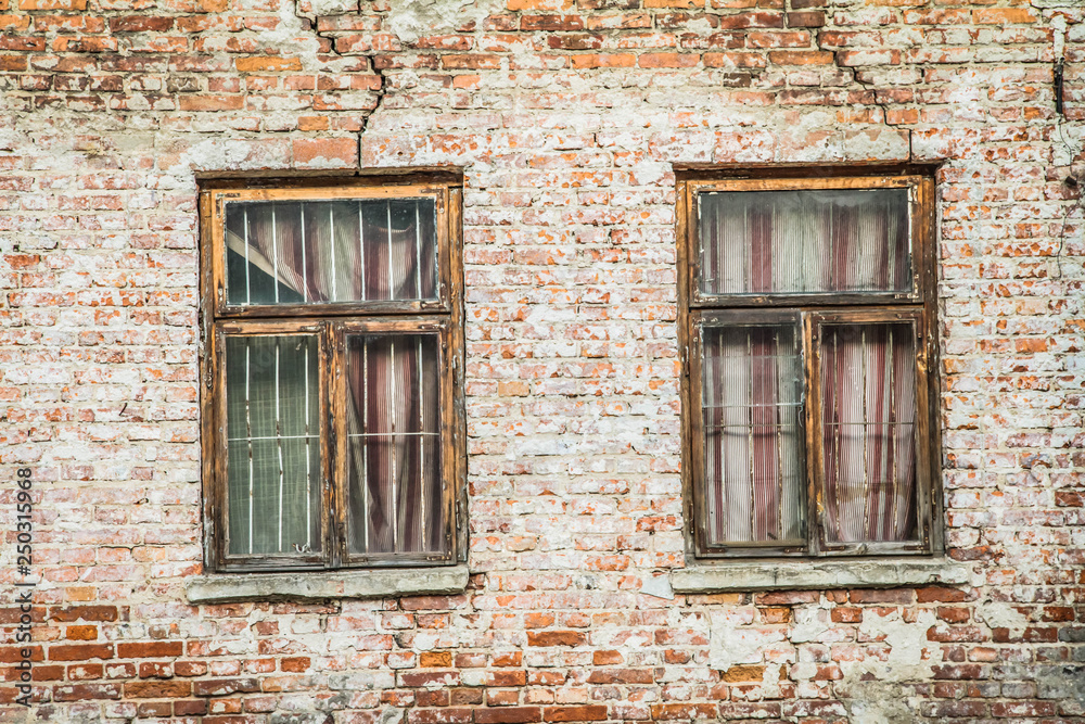 Abandoned brick building with broken windows