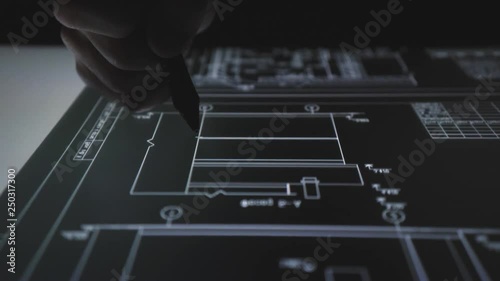 Creative Architect designer working with drawings on pen display tablet at night office. using interactive screen display tablet Computer 