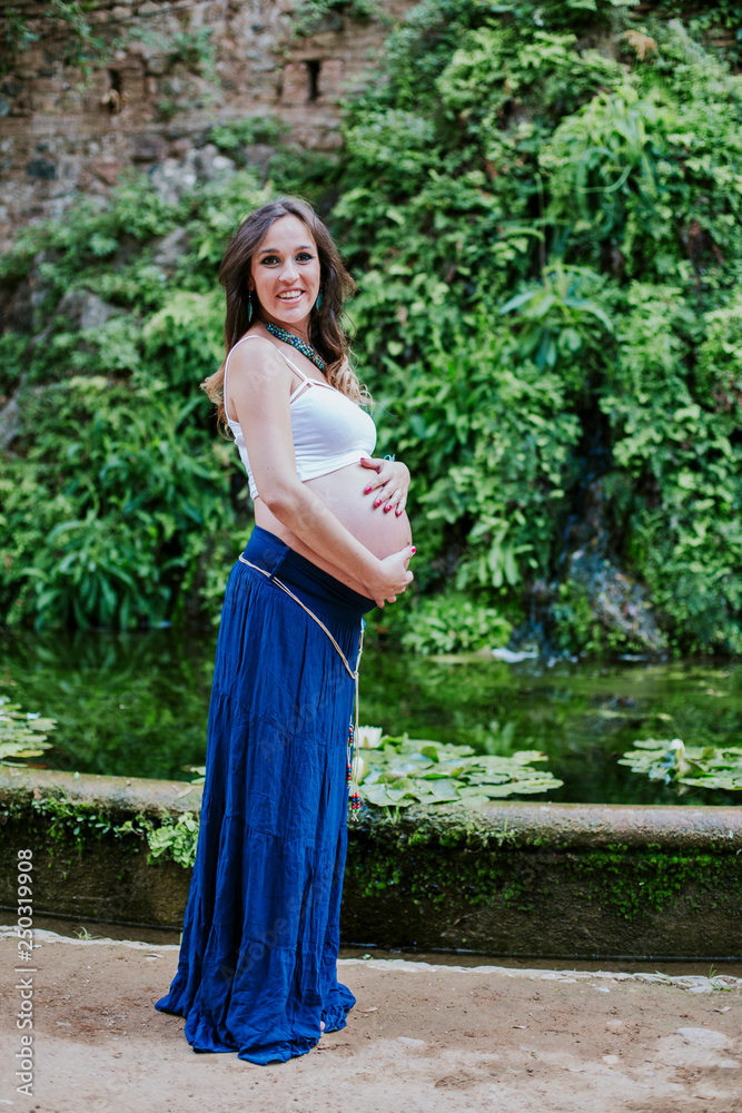 pregnant happy and smiling in the field