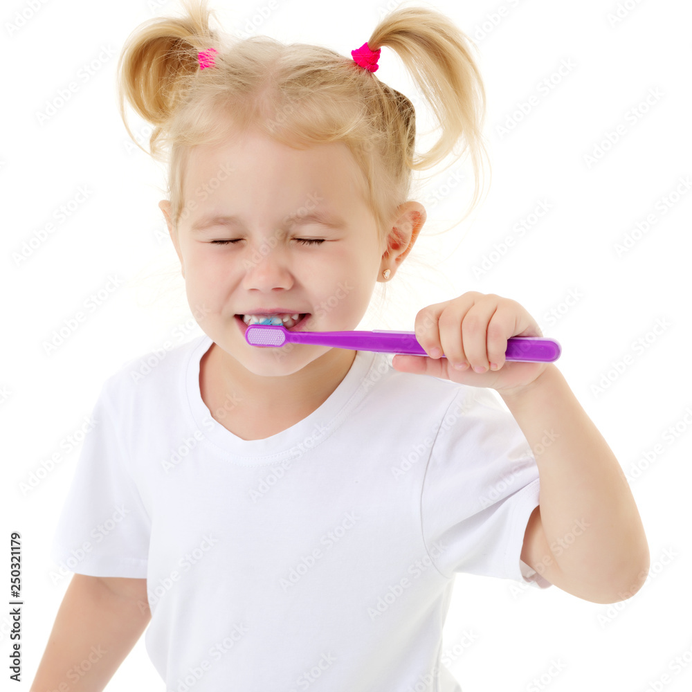 A little girl brushes her teeth. A little girl brushes her teeth.