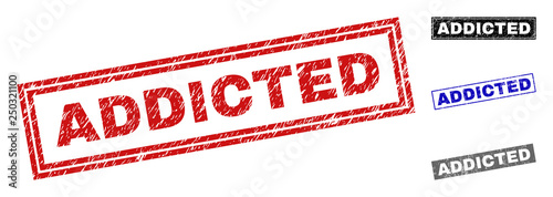 Grunge ADDICTED rectangle stamp seals isolated on a white background. Rectangular seals with distress texture in red, blue, black and grey colors.