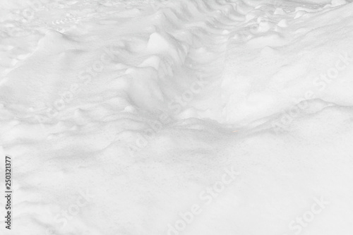 White snow with footprints. Abstract empty background.