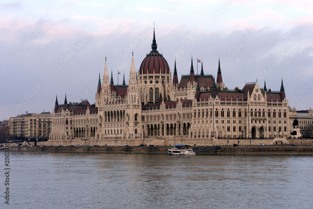 The building of the Hungarian Parliament on the banks of the Danube in Budapest is the main attraction of the Hungarian capital. Beautiful building against the gray sky. The building of the Hungarian Parliament on the banks of the Danube in Budapest is the main attraction of the Hungarian capital. Beautiful building against the gray sky.