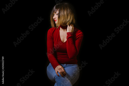 blonde woman posing on black background