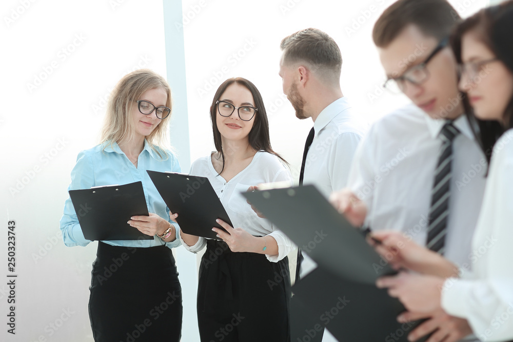 close up.employees read business documents standing in the office close up.employees read business documents standing in the office