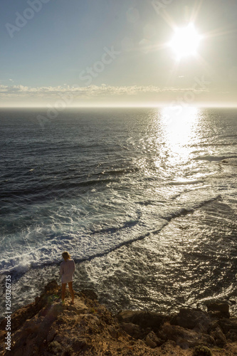 jung women standing on cliffs near port lincon at sunset, South Australia photo