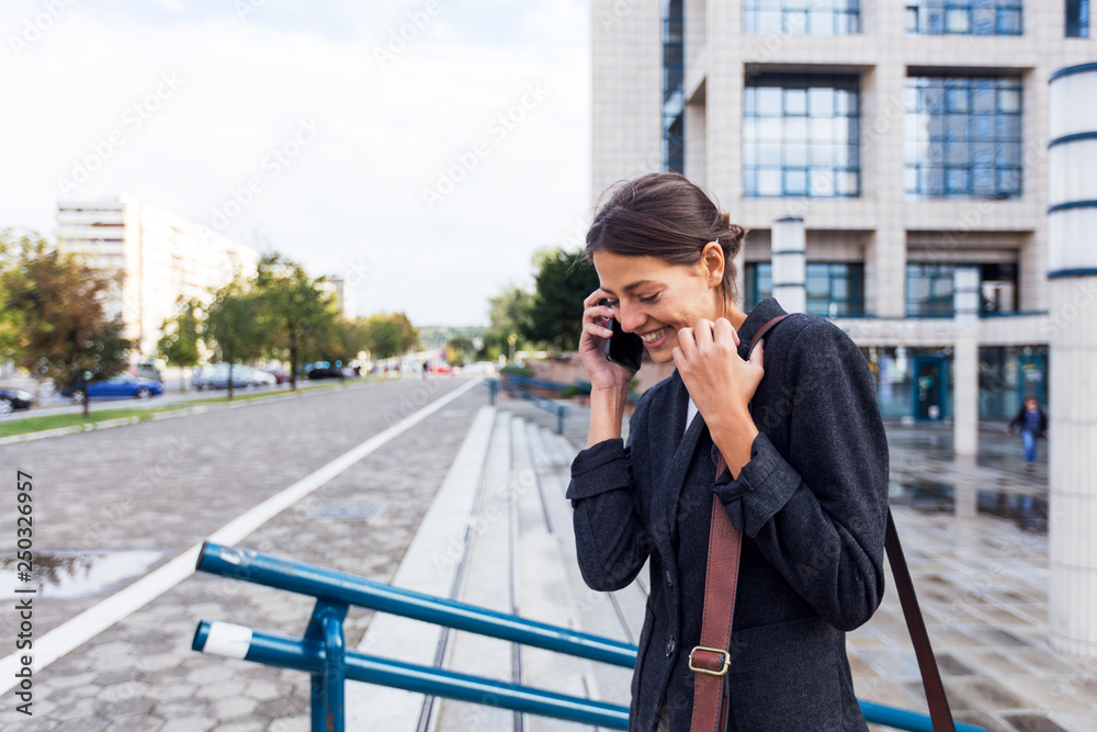 Fototapeta premium Handsome young businesswoman talking on the phone