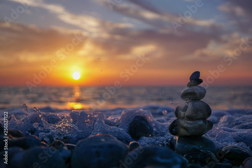 hareubang pebble reflection at sunset over the sea - zen and relaxation