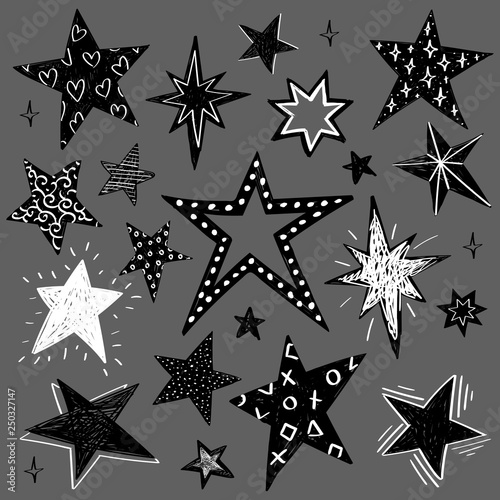 Set of black and white hand drawn vector stars in doodle style isolated on gray background. Could be used as pattern element  cards  childish design