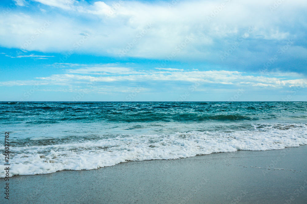 White sand and blue sea with waves White sand and blue sea with waves