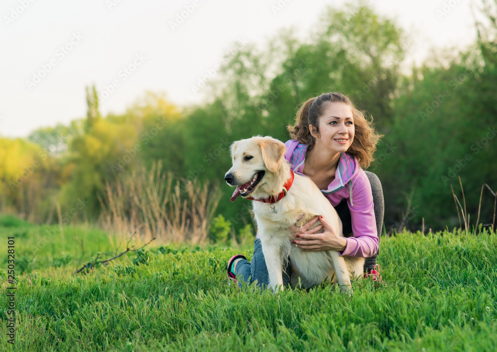 Portrait of young beautiful woman lying and hugging her golden retriever dog. Happiness and friendship. pet and woman. Portrait of young beautiful woman lying and hugging her golden retriever dog. Happiness and friendship. pet and woman.