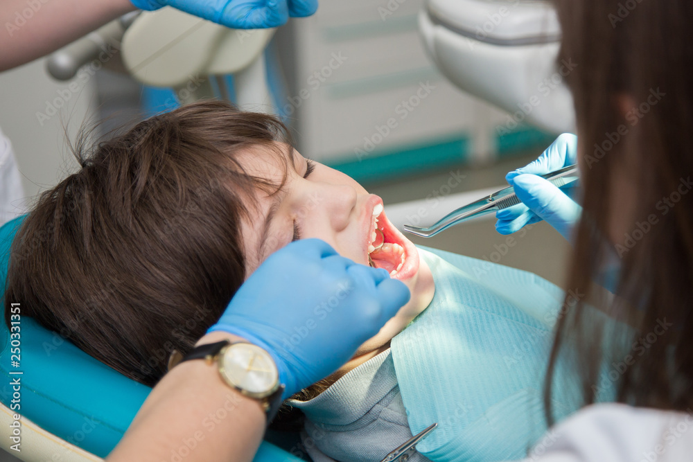 Boy at a dentist office, new teeth examination and treatment of cavities Boy at a dentist office, new teeth examination and treatment of cavities