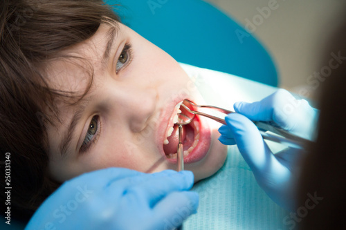 Boy at a dentist office, new teeth examination and treatment of cavities