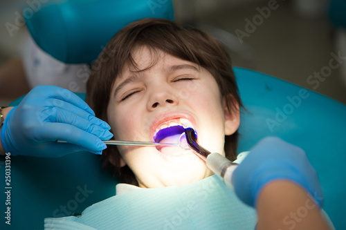 Boy at a dentist office, new teeth examination and treatment of cavities