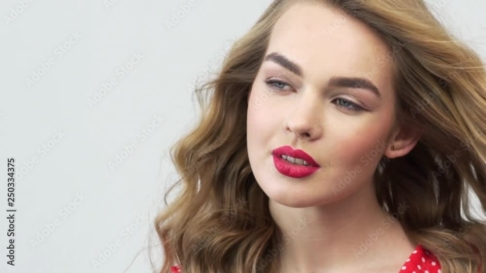 Beautiful woman with long curly hair. Fashion model with a red lipstick on lips. Beautiful woman with long curly hair. Fashion model with a red lipstick on lips.