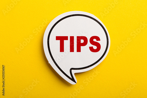 Tips Speech Bubble Isolated On Yellow Background photo