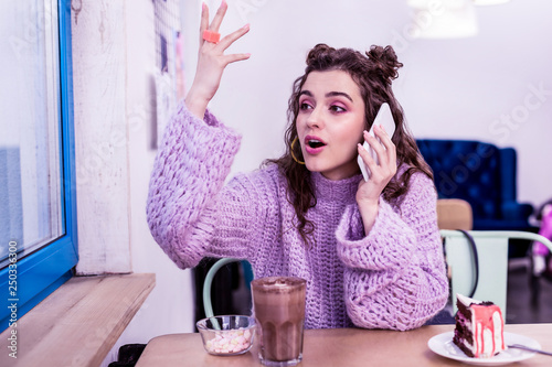 Expressive long-haired lady actively gesturing during conversation photo