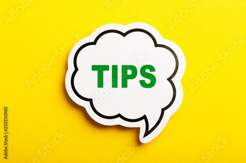 Tips Speech Bubble Isolated On Yellow Background photo