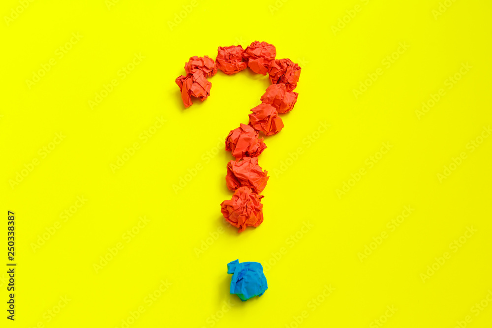 Question mark lined with crumpled paper on yellow background top view copy space Question mark lined with crumpled paper on yellow background top view copy space